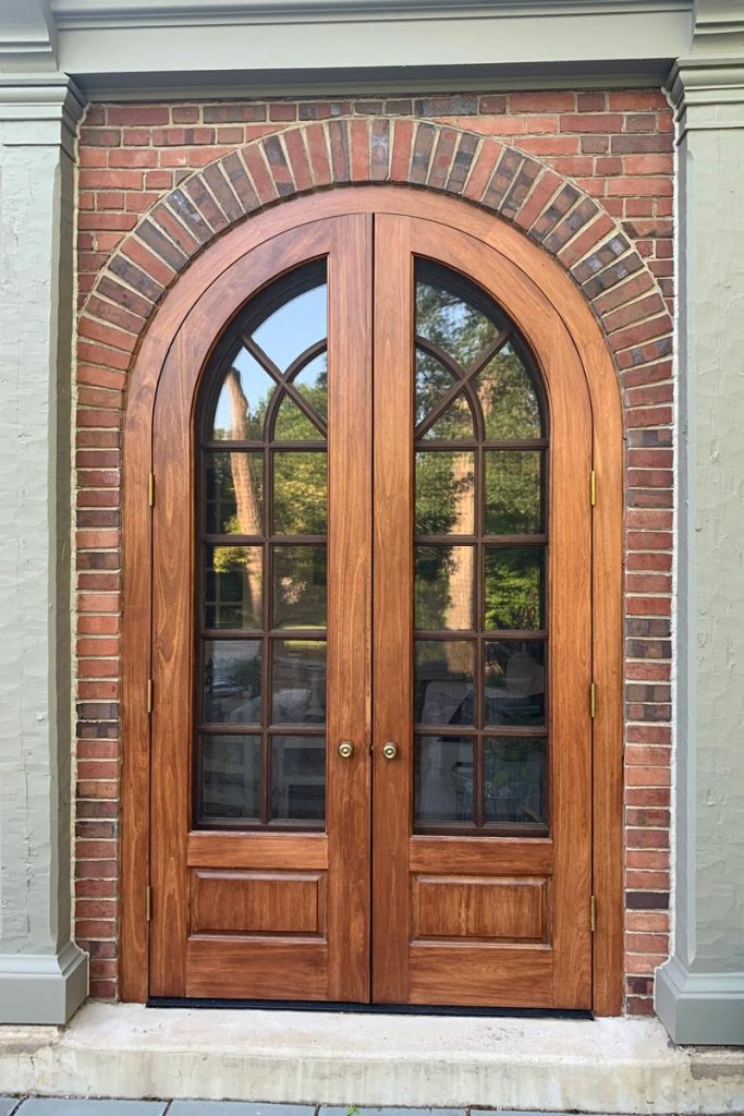 wooden arch front doors with glass panels