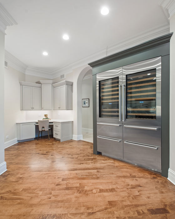 hallway leading out of kitchen to large oven and separate isolated seating area with built in cabinets