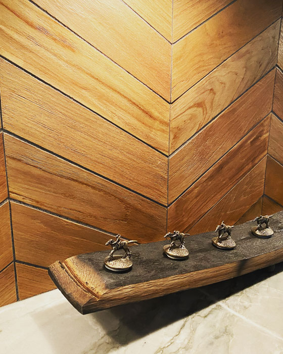 close up of a figurine in bathroom with wooden walls