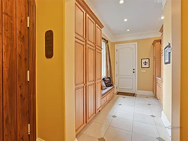 before finished mud room with brown built in cabinets and yellow walls