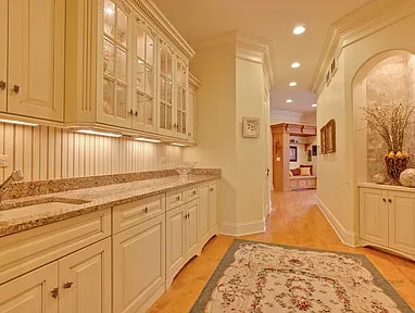 before transformation of a hallway from kitchen to living room- yellow cabinets, countertops, walls and floor