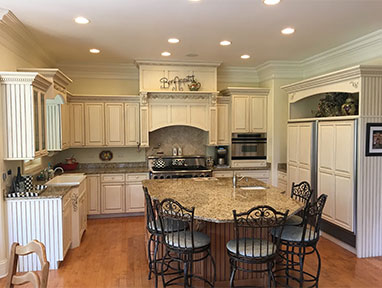 before kitchen- island countertops along with bar seating around. outdated custom cabinets